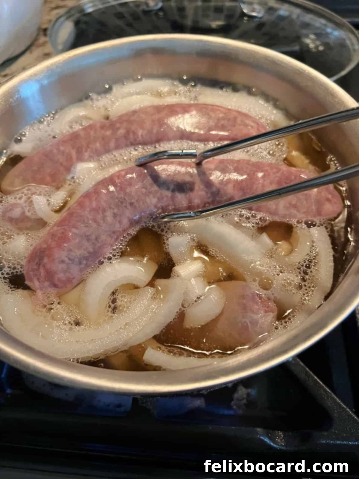 Classic Wisconsin Beer Brats 4 Placing raw bratwurst carefully into a pot of gently boiling beer with sliced onions.