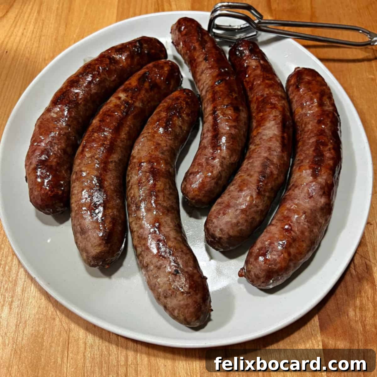 Classic Wisconsin Beer Brats 9 A perfectly arranged plate featuring grilled Wisconsin beer brats and classic side dishes, including potato salad and baked beans.