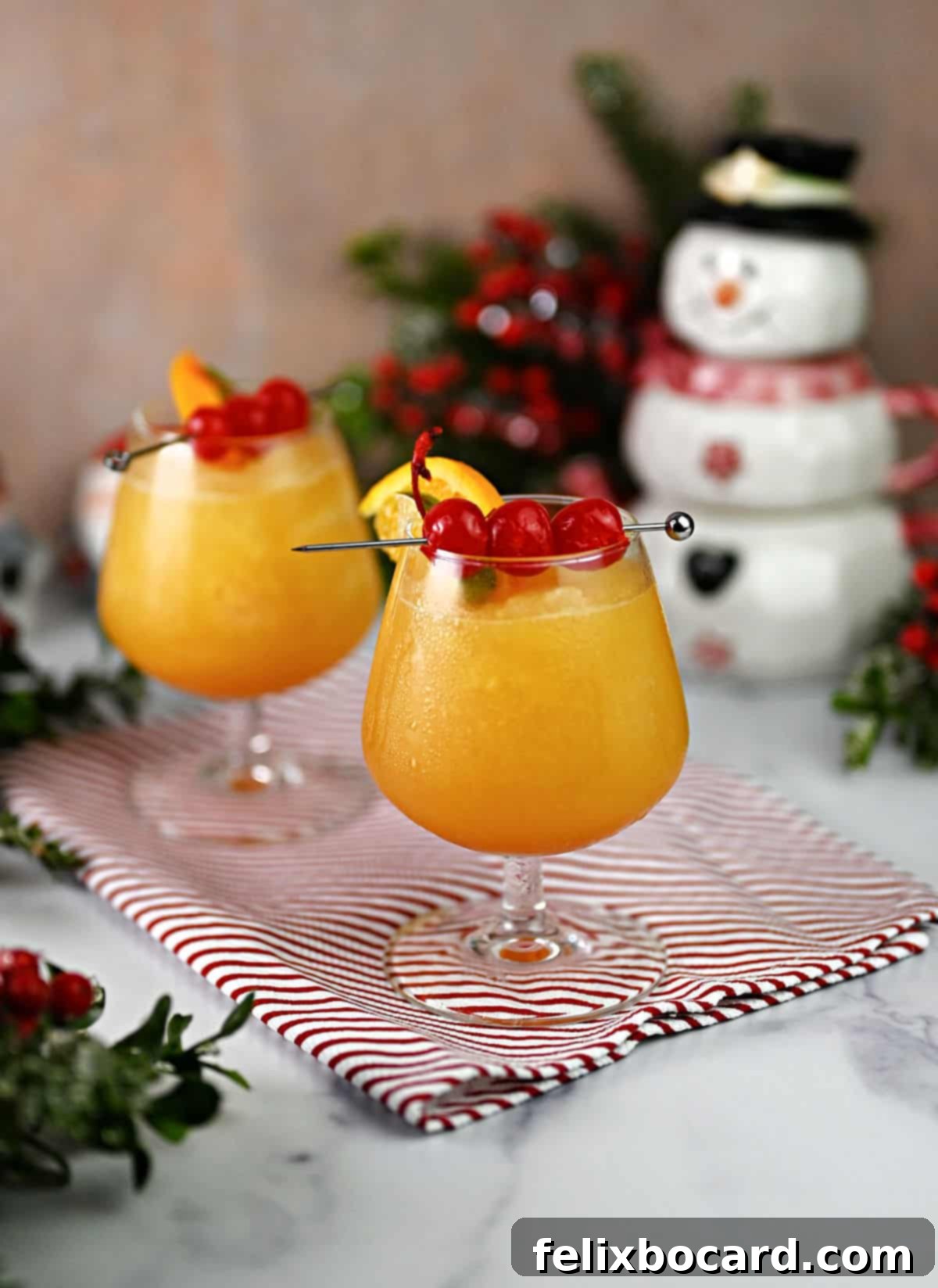 Two glasses of festive Wisconsin Brandy Slush in a cozy winter setting, adorned with a sprinkle of snow and holiday decor, showcasing its versatility beyond summer.