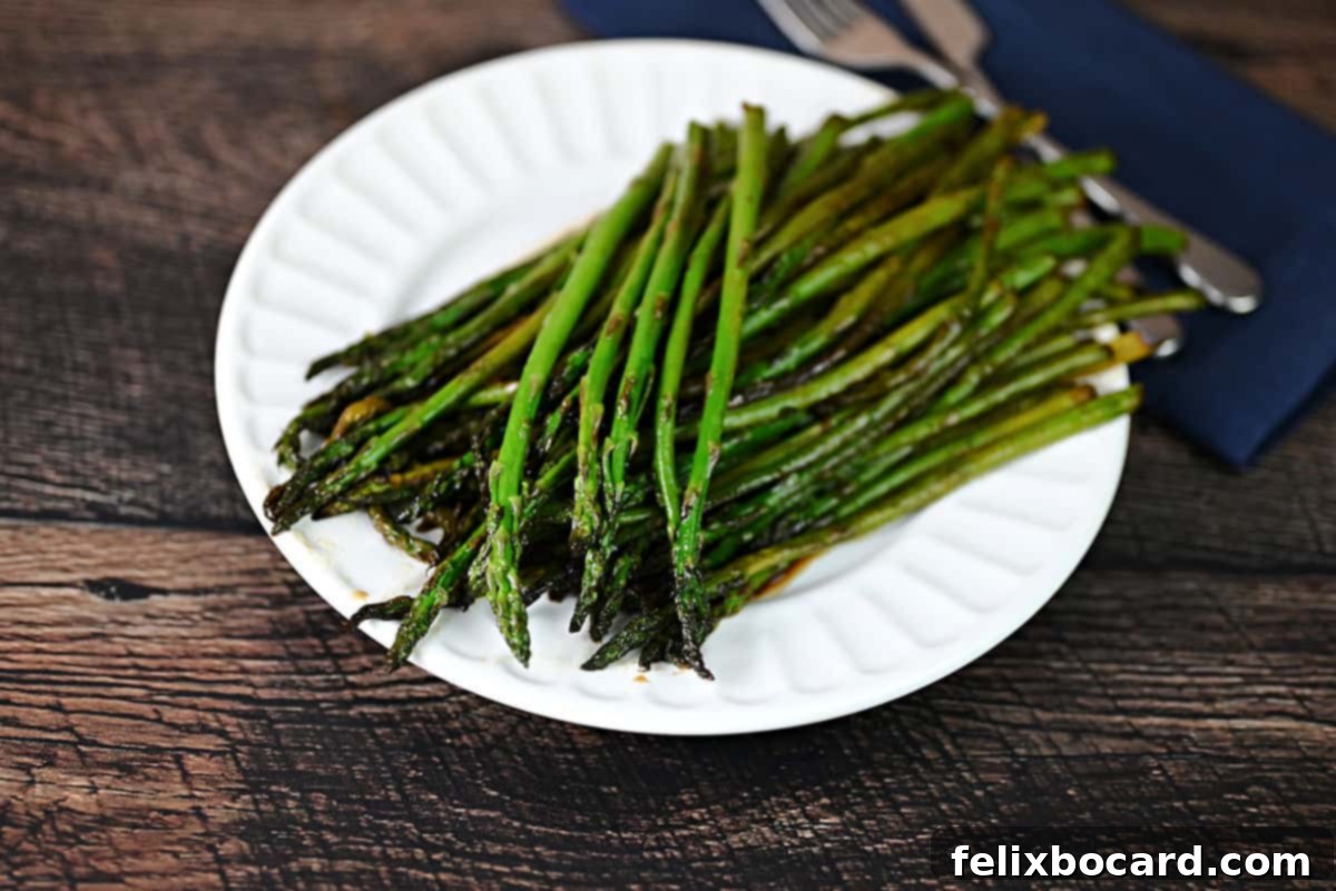 Plate of perfectly sautéed asparagus with a glistening balsamic glaze, ready to serve.