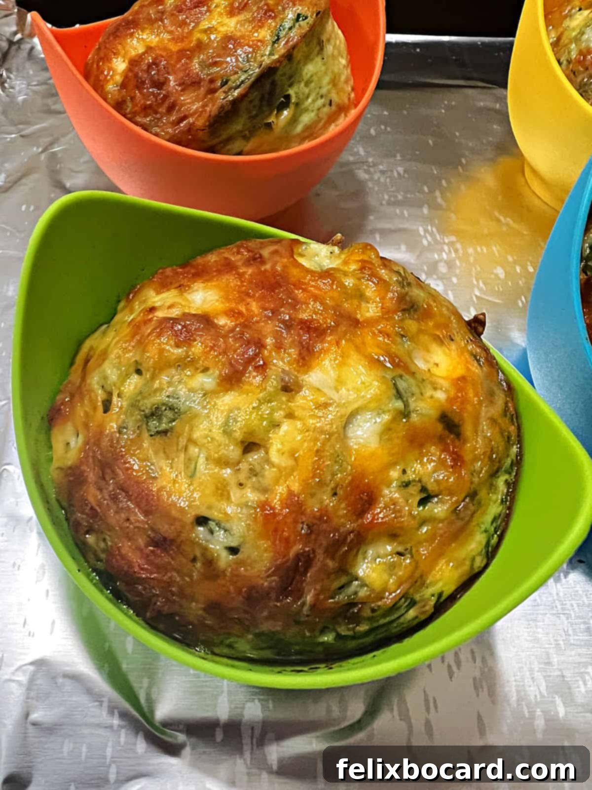 Freshly cooked air fryer egg bites in colorful silicone cups, ready to serve.