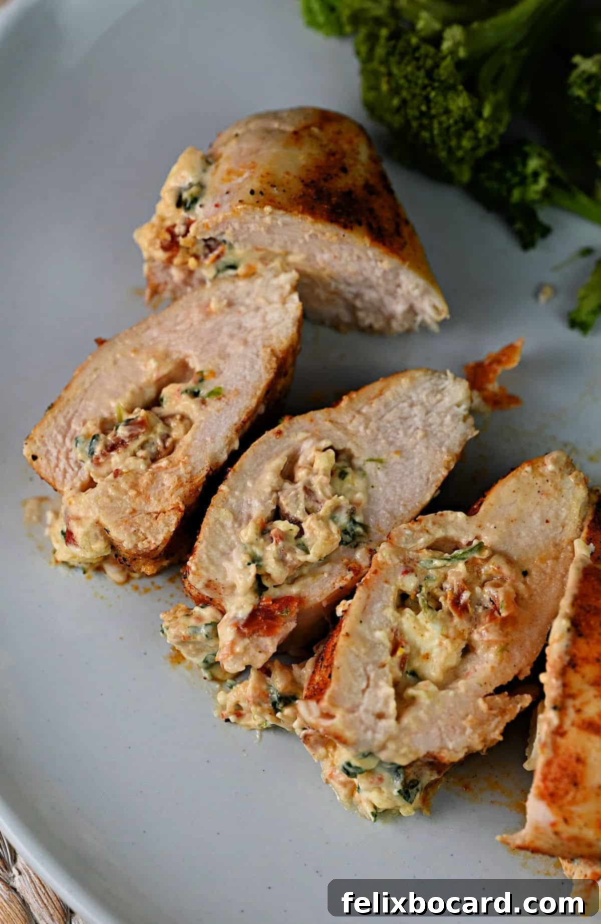 air fryer cooked stuffed chicken breast in slices on a plate.