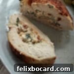Stuffed chicken breast cooked in the air fryer and sliced to show the filling inside.