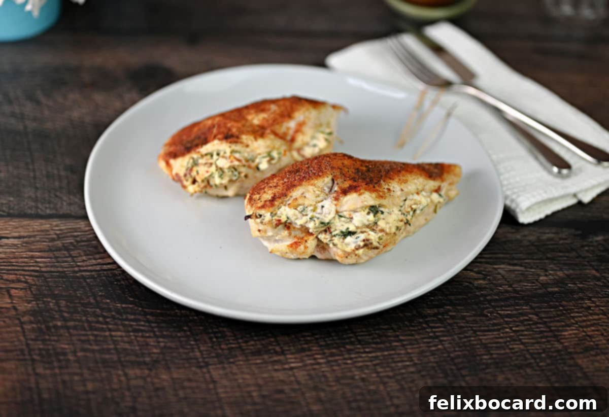 2 stuffed chicken breasts on a plate ready to be served.