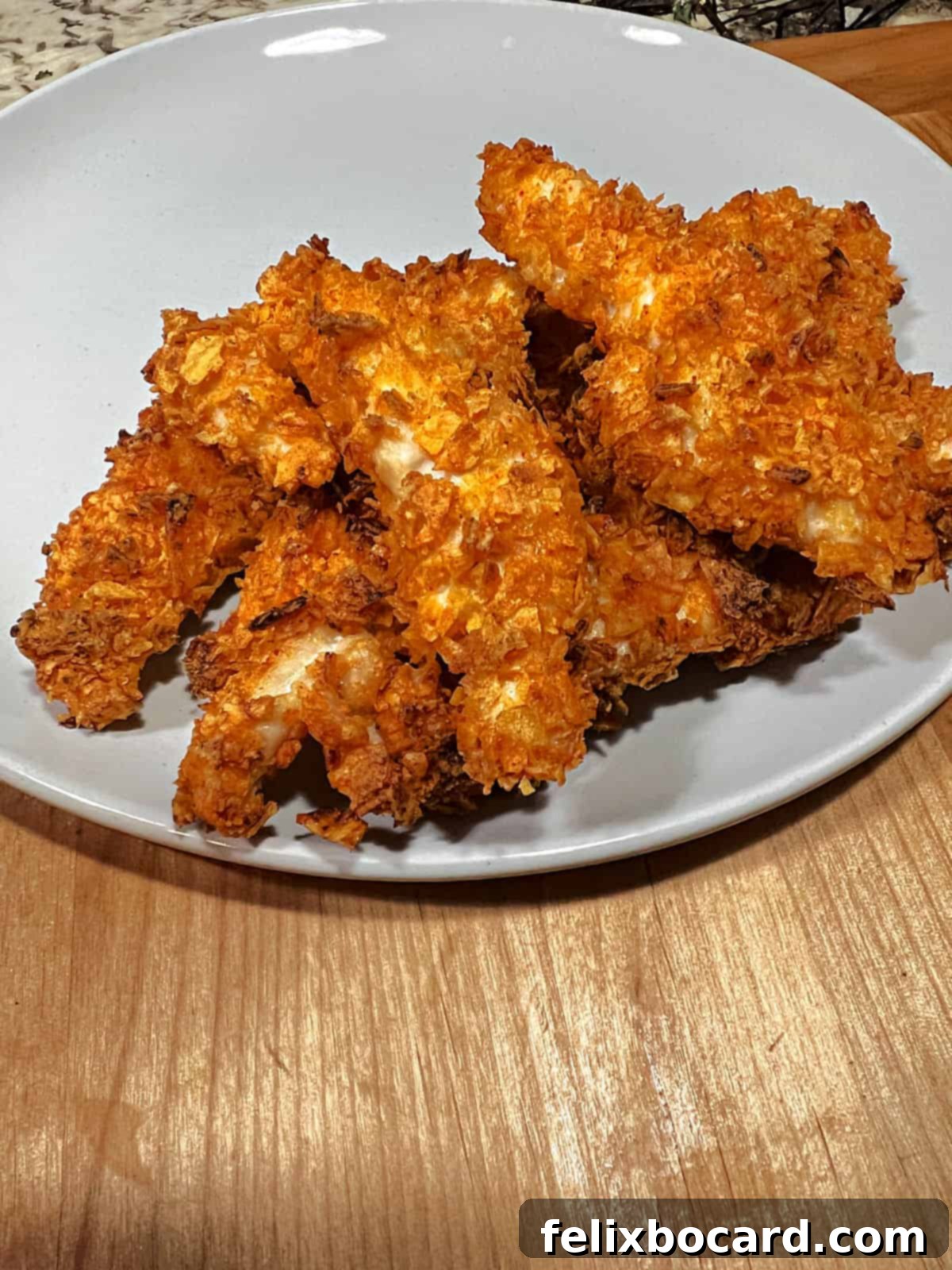 Crunchy Doritos Air Fryer Chicken Tenders 12 A generous pile of crispy Air Fryer Doritos chicken tenders arranged on a plate, ready to be served.