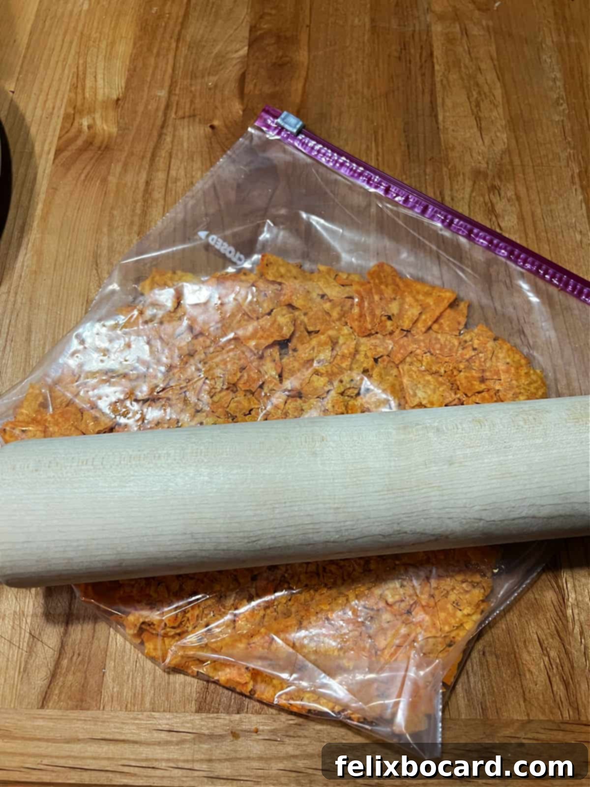 Crunchy Doritos Air Fryer Chicken Tenders 4 Using a rolling pin to crush Doritos chips inside a resealable bag.