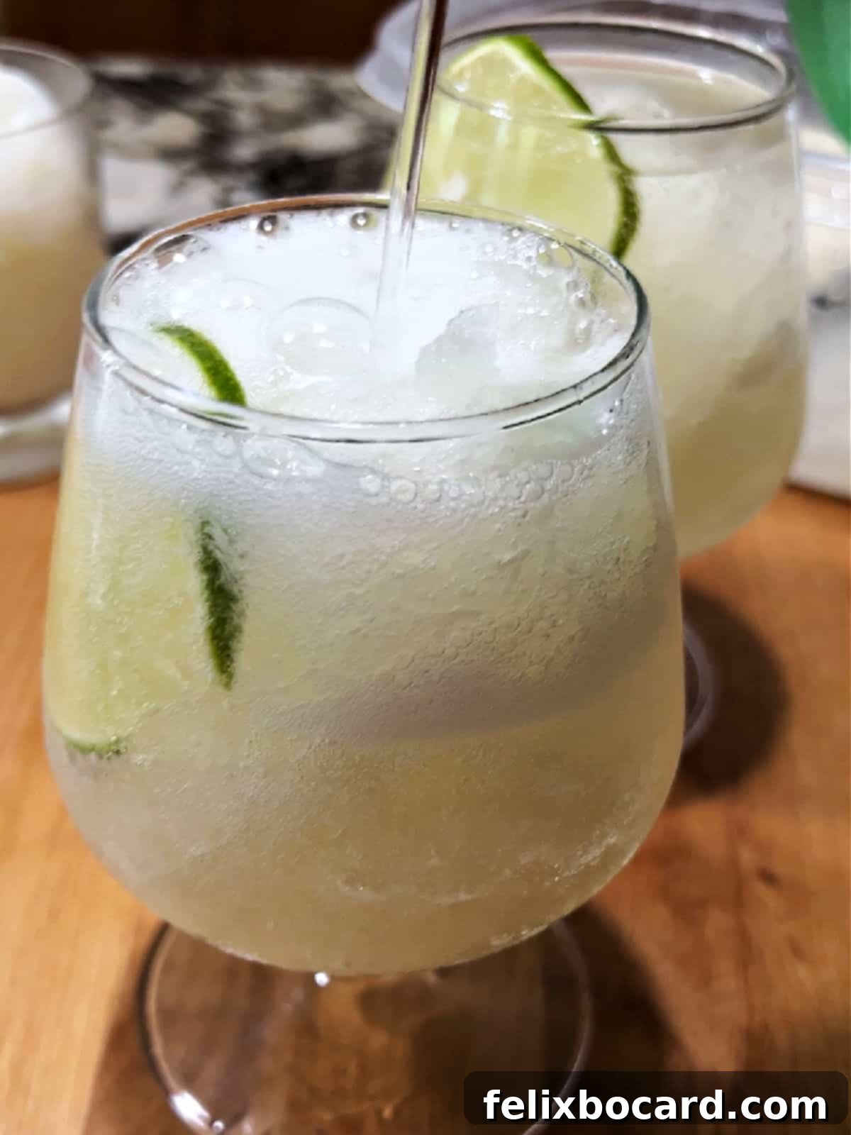 Blended Daiquiri Bliss 7 Adding soda to the frozen daiquiri slush in the glass to be served.