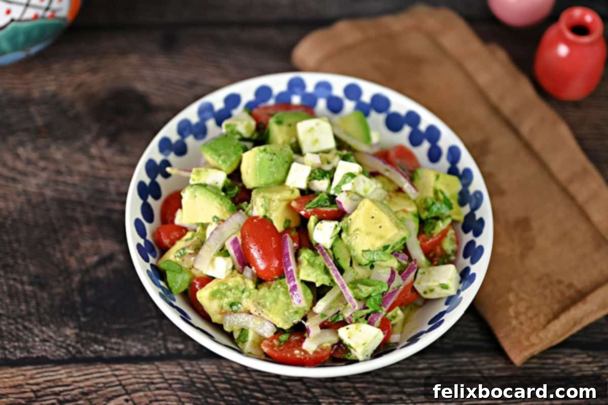 A vibrant bowl of freshly prepared Mexican Avocado Salad, ready to be served.