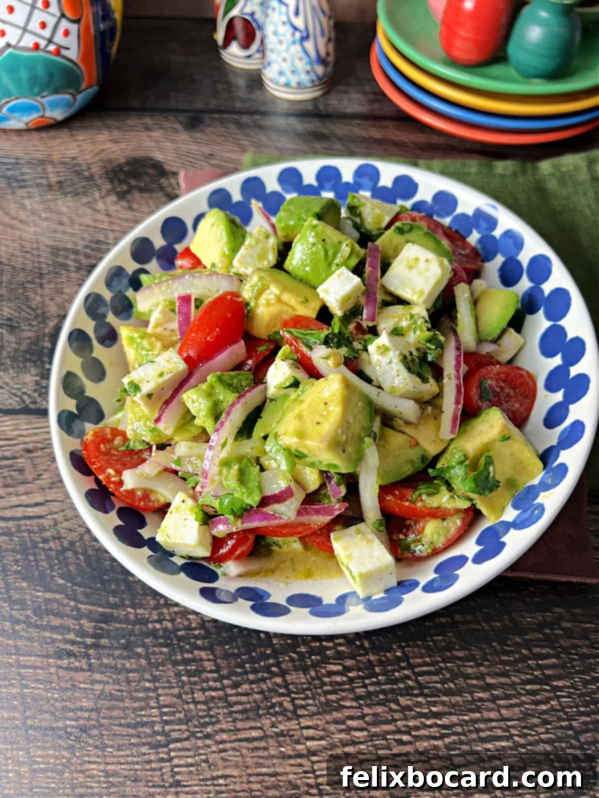 A beautifully presented serving bowl filled with Mexican Avocado Salad, showcasing its fresh ingredients and vibrant colors.