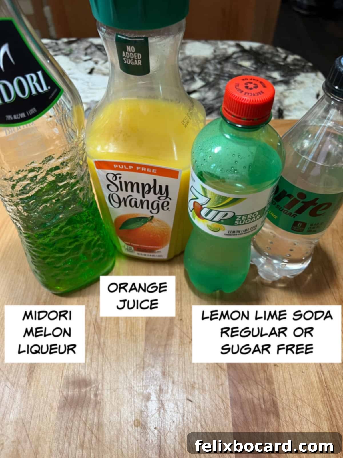 Monster Mash Punch 3 Ingredients: Midori melon liqueur, orange juice, and lemon lime soda.