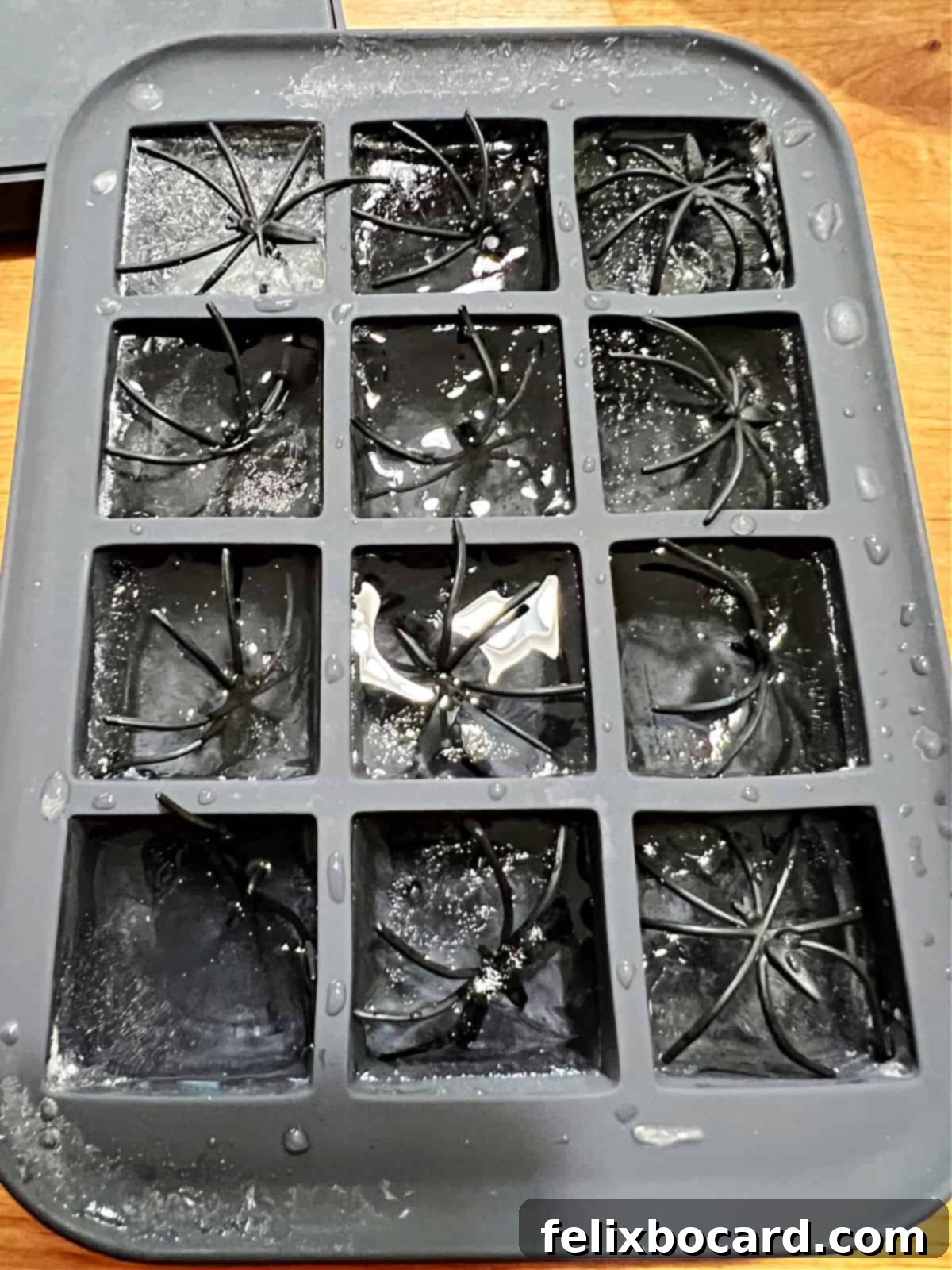 Monster Mash Punch 8 Plastic spiders freezing in the ice in ice cube tray.