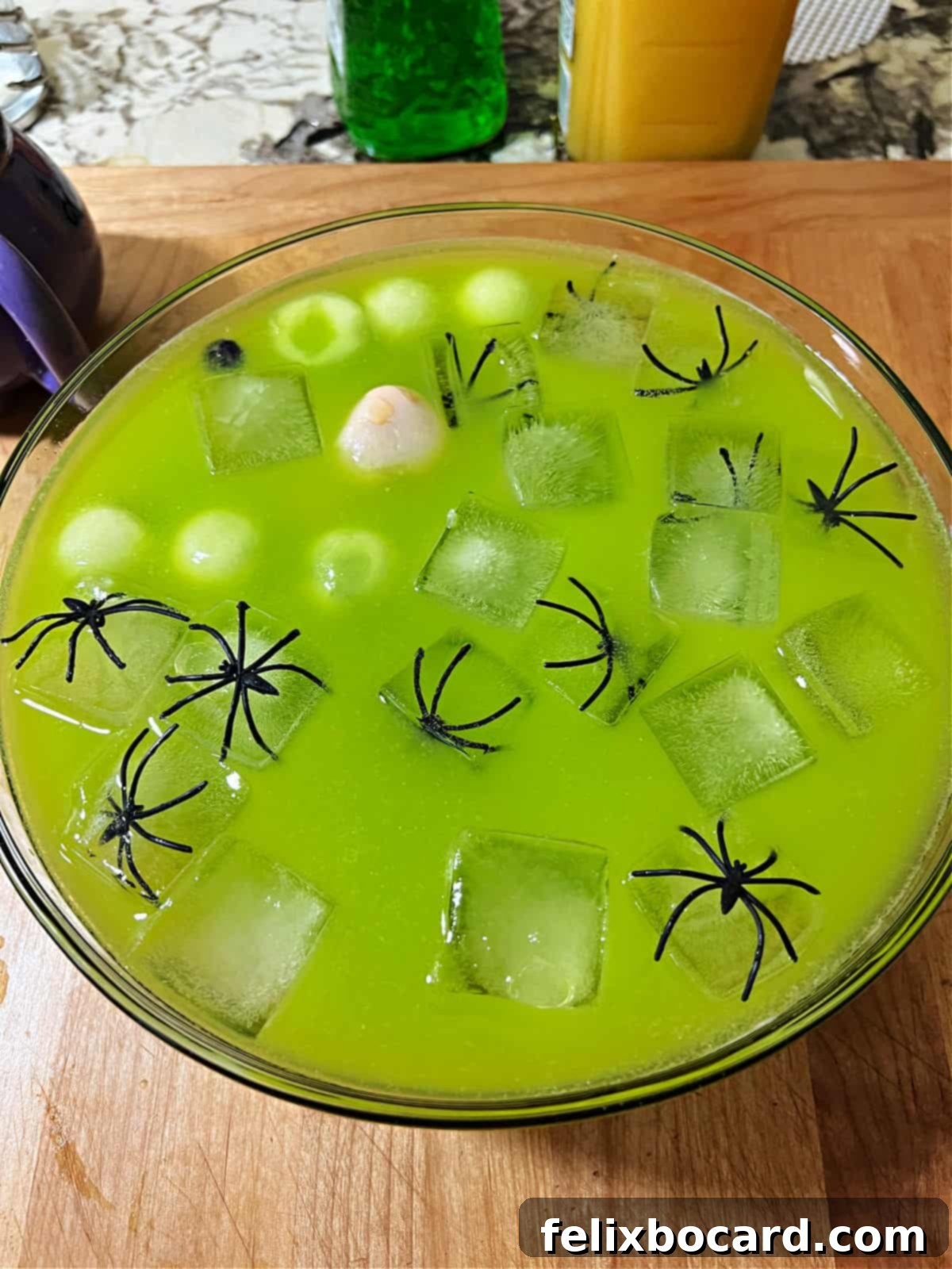Monster Mash Punch 9 Punch bowl of witches brew cocktail showing floating ice, spiders, and eyeballs.
