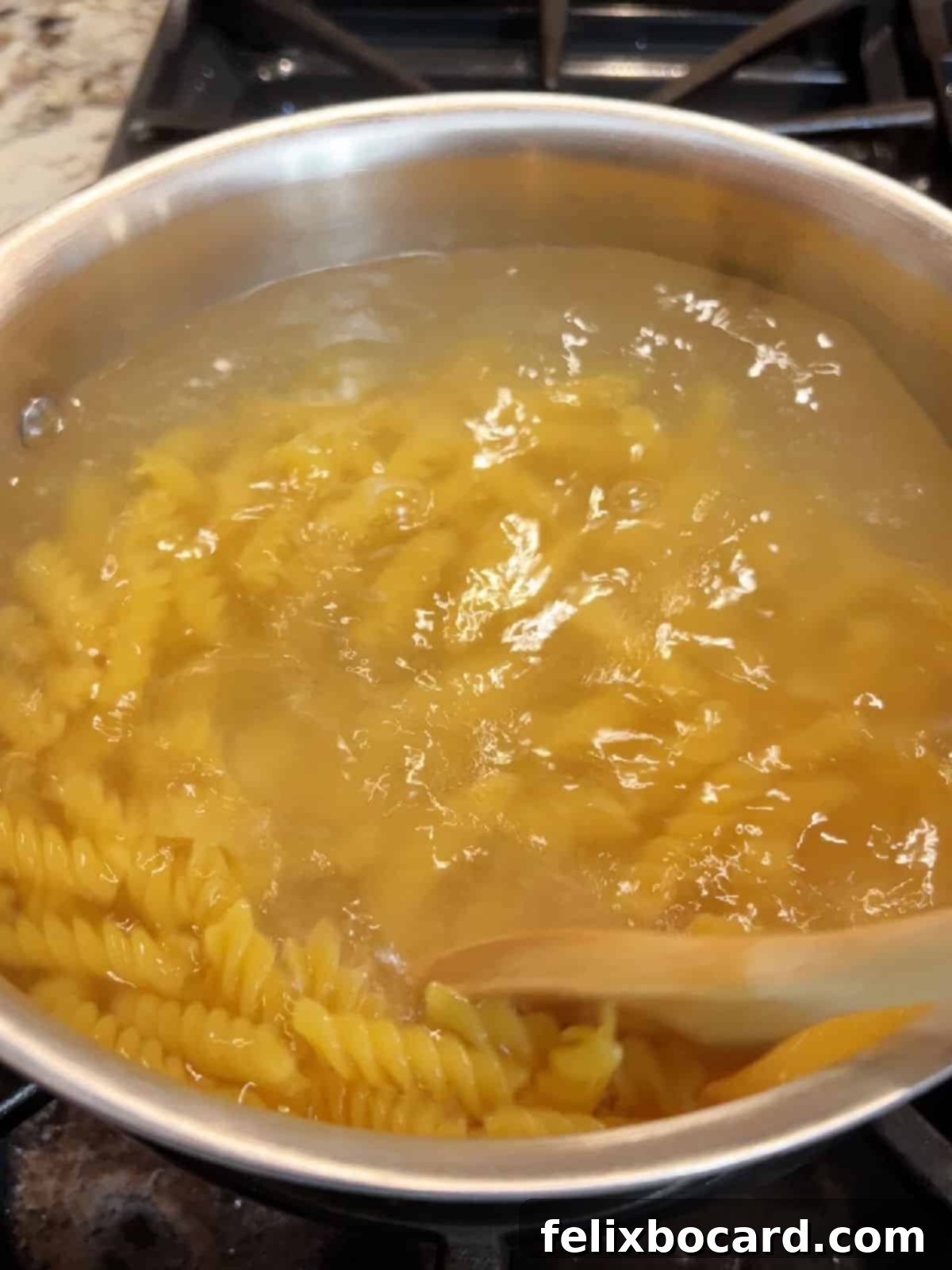 Rotini pasta boiling in water.