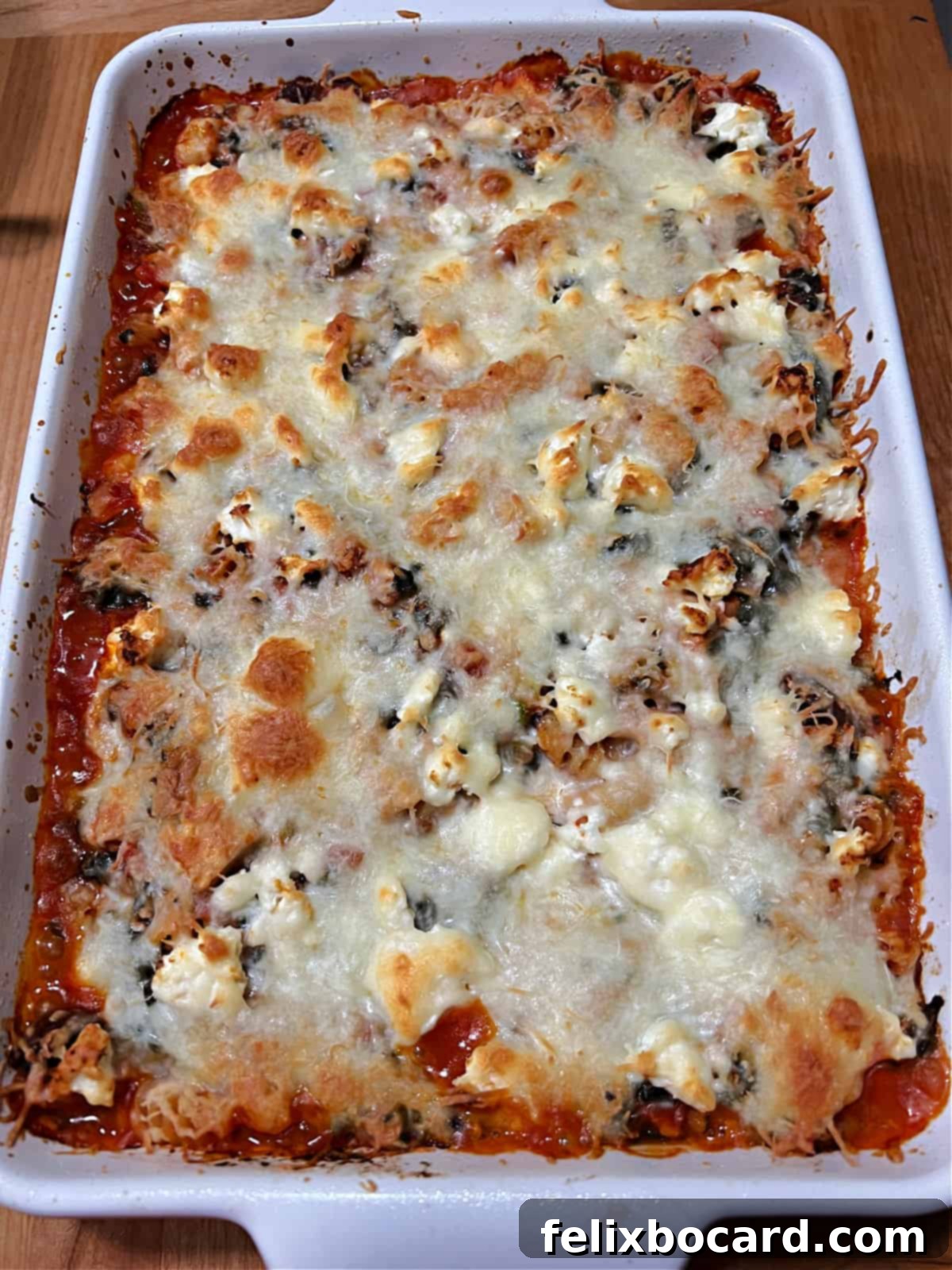 Baked casserole showing the melted cheese and bubbly edges.