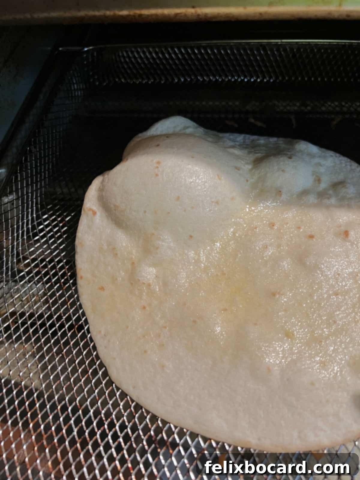 Large bubble in a cooking tortilla.