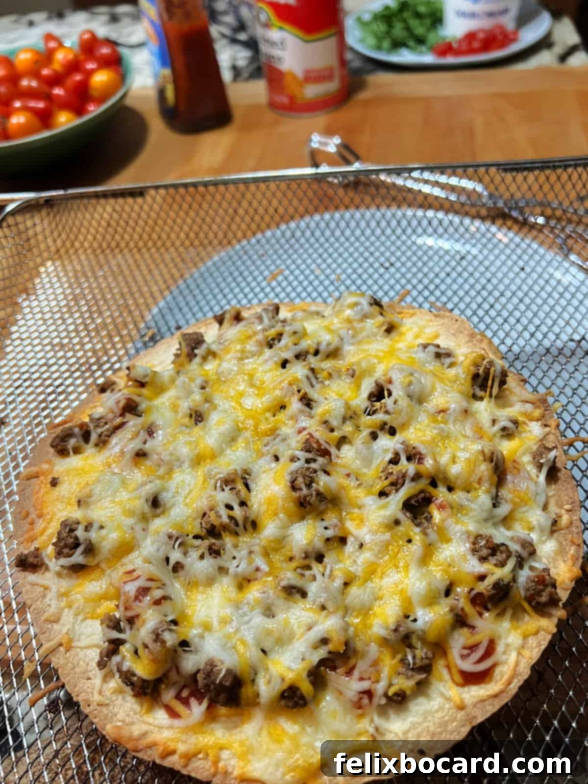 Air fried pizza showing melted cheese.
