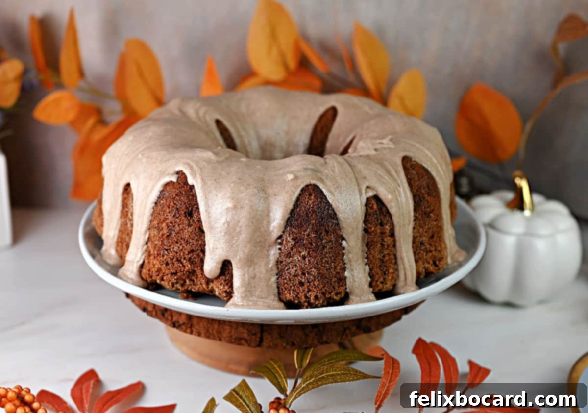 Old fashioned fresh apple cake made in a Bundt pan and drizzled with a thick cinnamon glaze frosting.