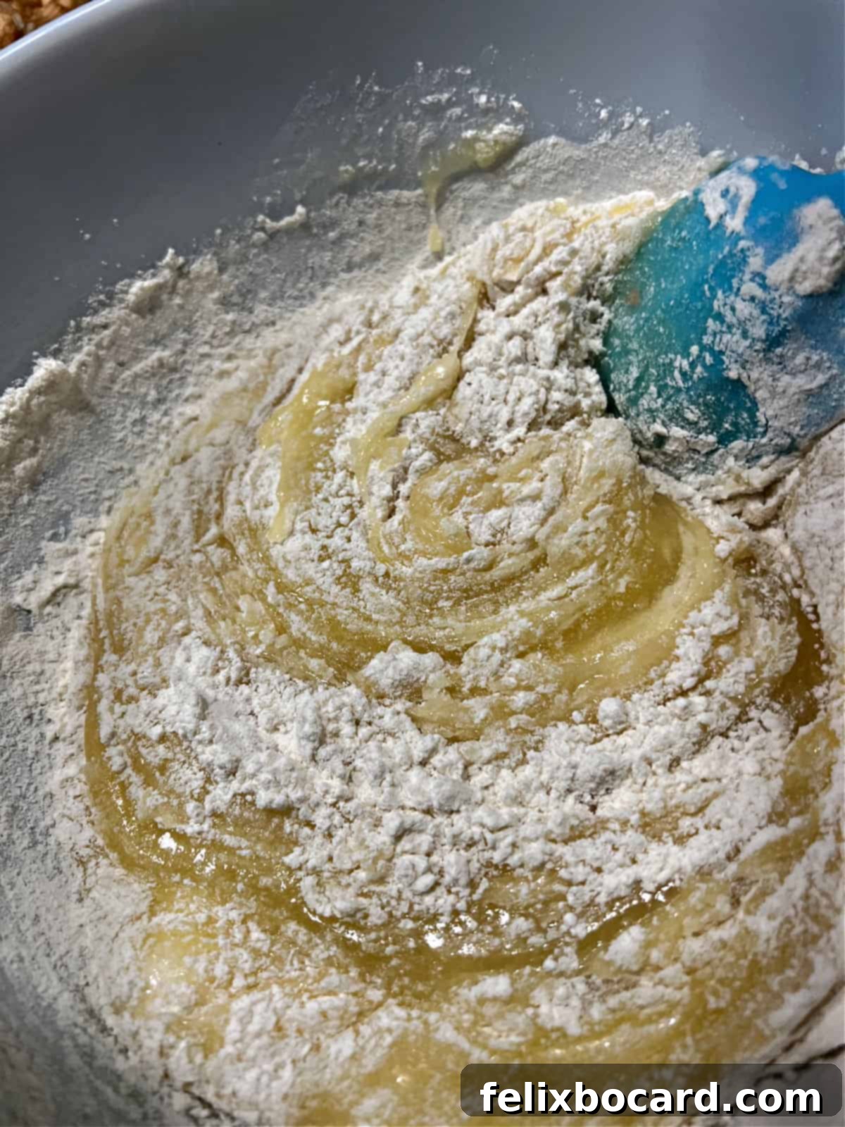 Mixing dry ingredients into the batter.