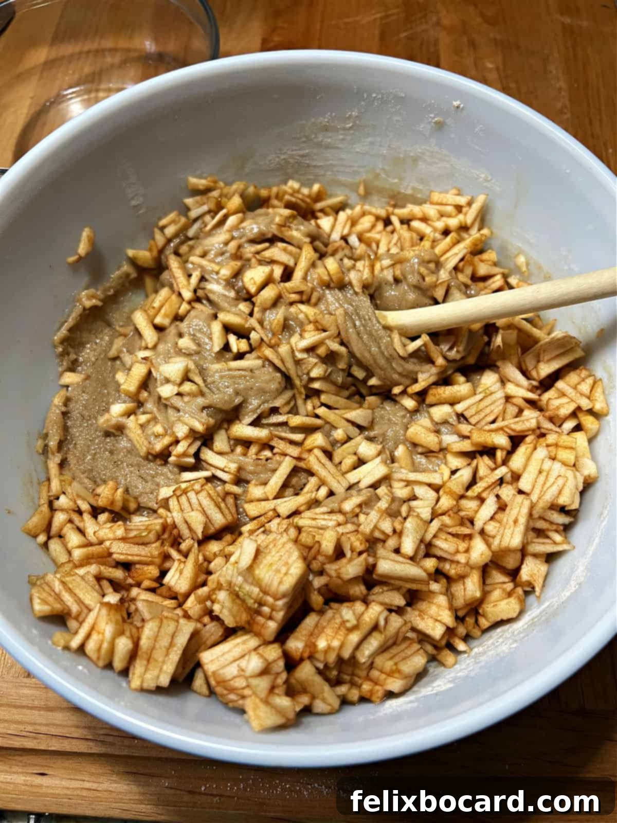 Adding chopped apples to the batter.