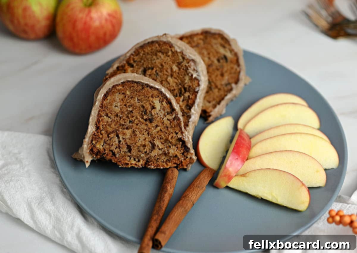 Slices of old fashioned fresh apple cake on a plate with apple slices.