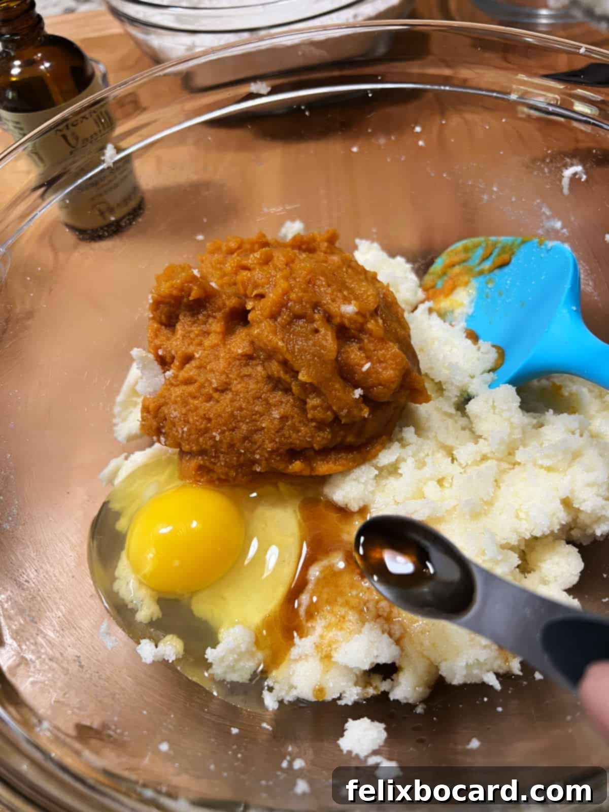 Adding the wet ingredients to the butter and sugar in the bowl.
