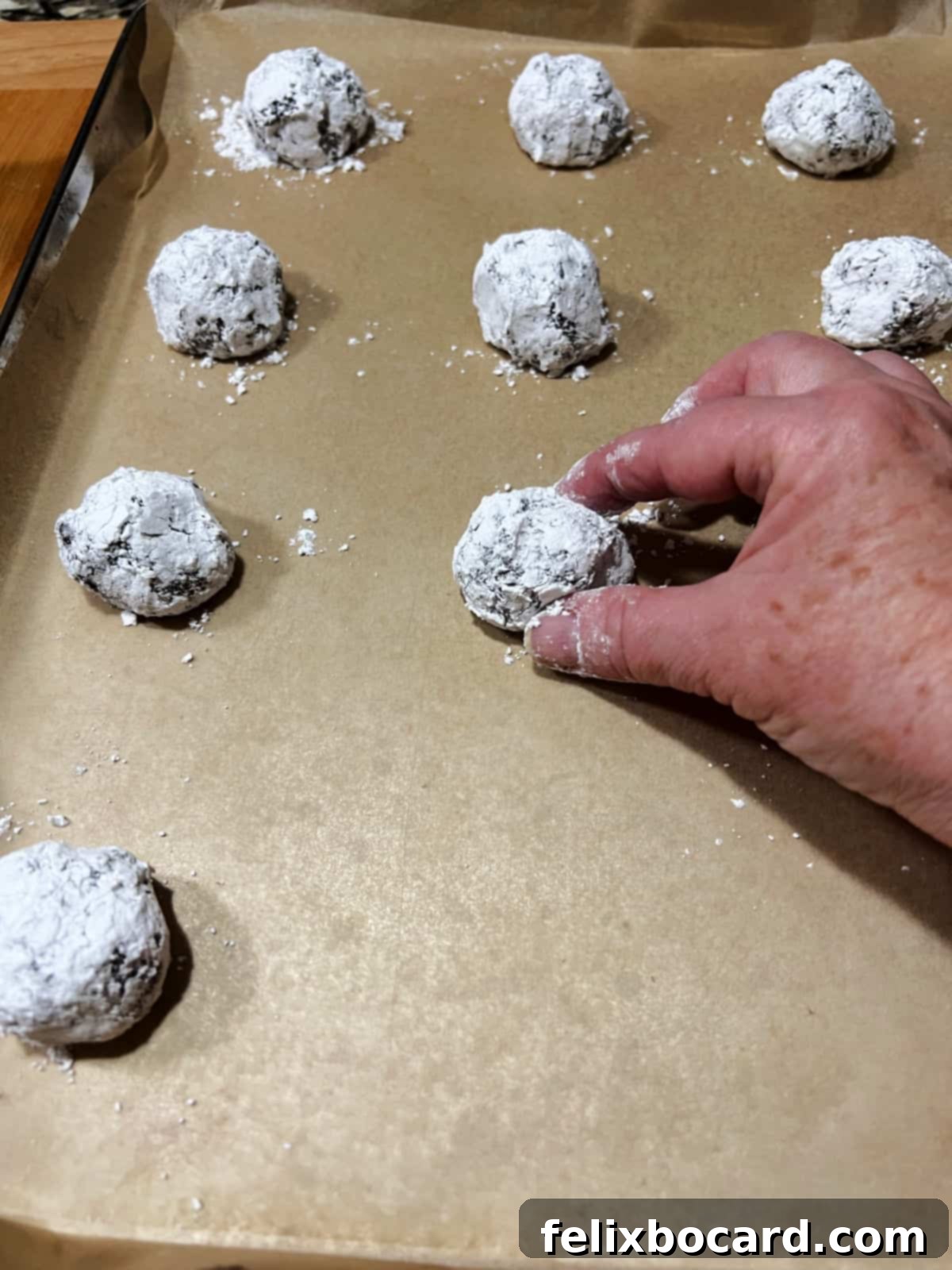 setting the coated dough balls on the baking sheet.