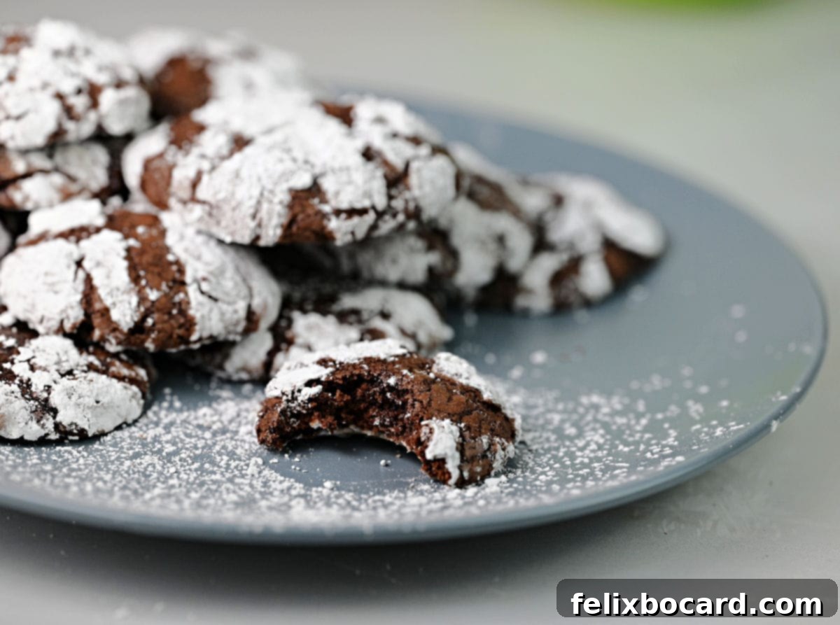 a blue plate with brownie mix crinkle cookies, with a bite taken out of one.