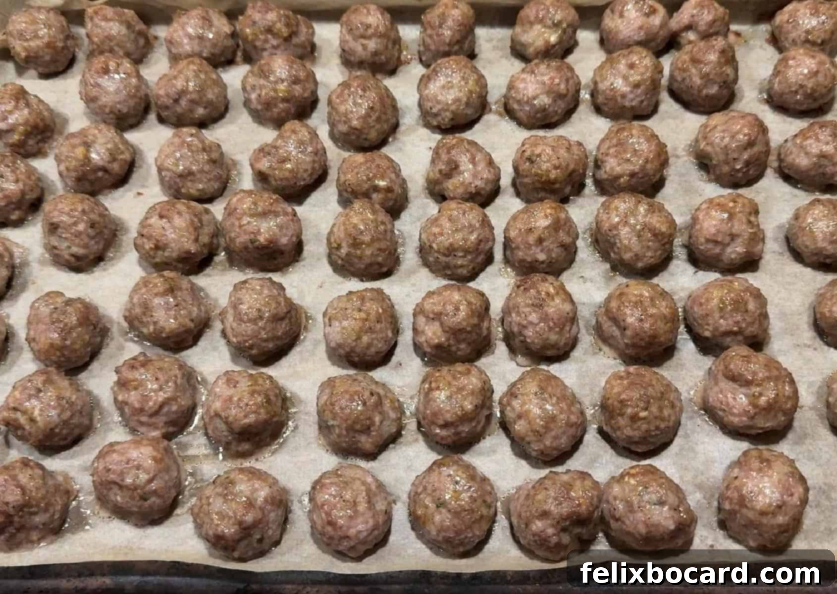 Make Ahead Freezer Meatballs 5 A large baking sheet filled with golden-brown, cooked meatballs, some with a hint of crispness, ready to be cooled and prepared for freezing as part of a smart meal prep strategy.