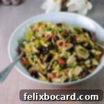 More Than Twenty Dried Cranberry Creations 12 A serving bowl brimming with shaved Brussels sprouts and cranberry salad, ready for serving.