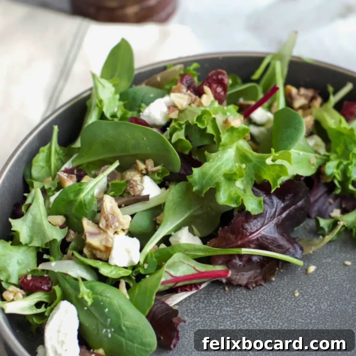 More Than Twenty Dried Cranberry Creations 14 A festive Christmas salad featuring baby greens, spinach, roasted chestnuts, dried cranberries, and crumbled feta cheese, drizzled with a cranberry balsamic vinaigrette.