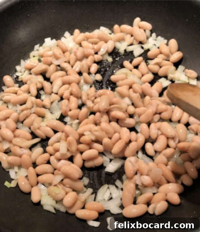 Cannellini beans and chopped onion ready for cooking