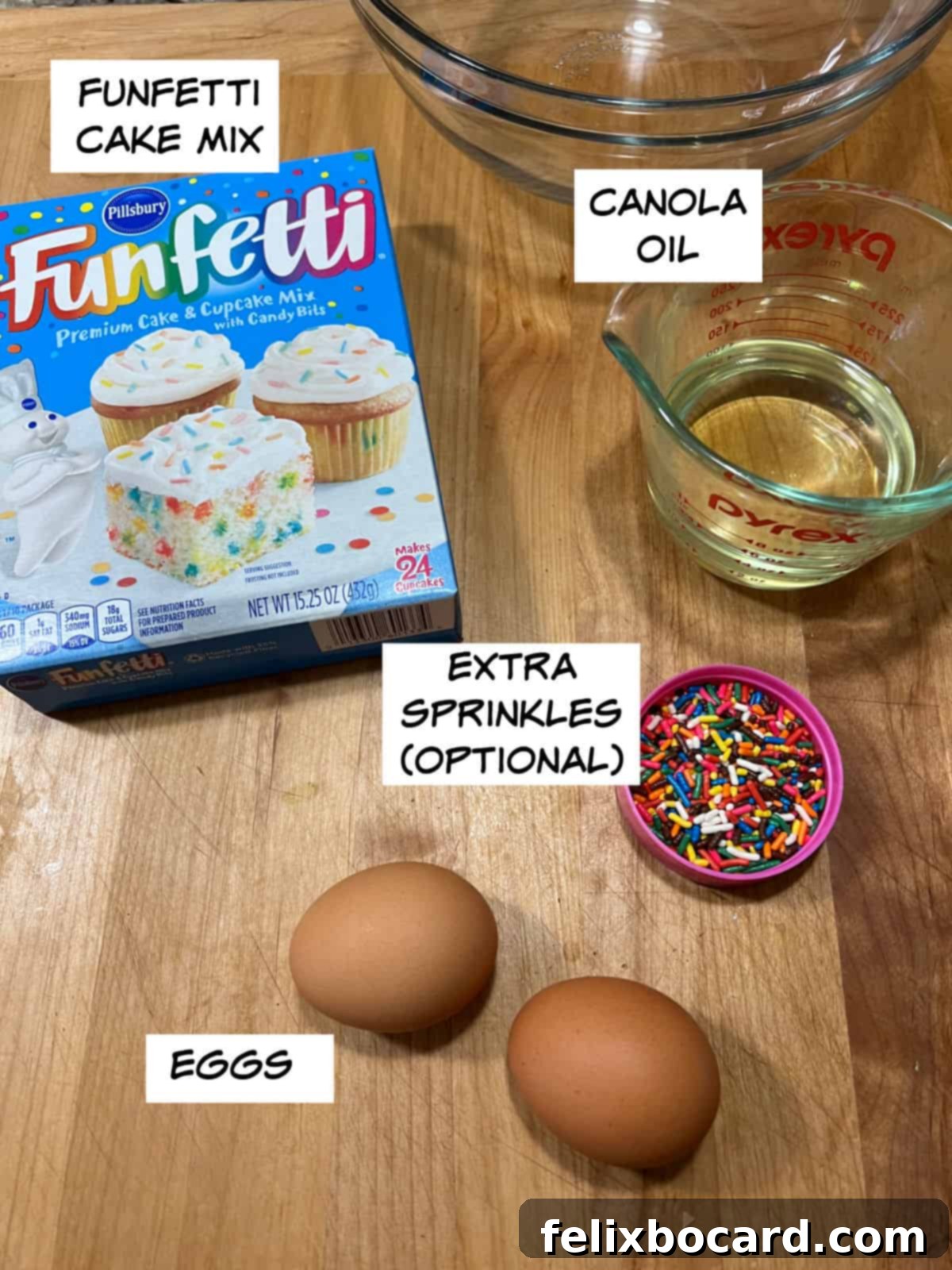 Ingredients for Funfetti Cake Mix Cookies: Funfetti cake mix box, canola oil, two eggs, and a jar of extra sprinkles.