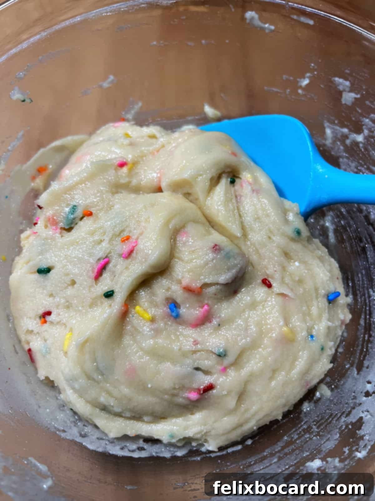 Mixed Funfetti cookie dough in a mixing bowl.