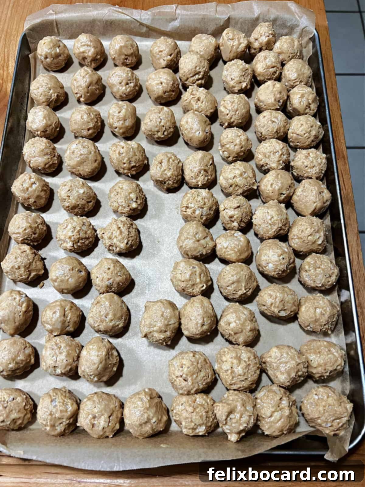 A baking tray full of uncoated peanut butter balls.