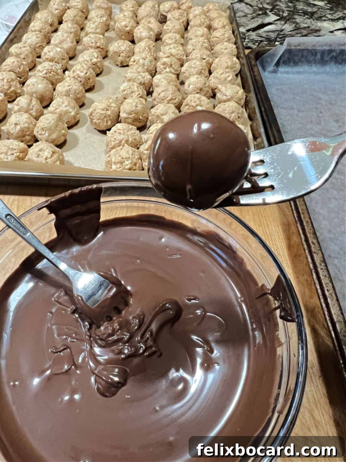 coated ball lifted out of the chocolate.