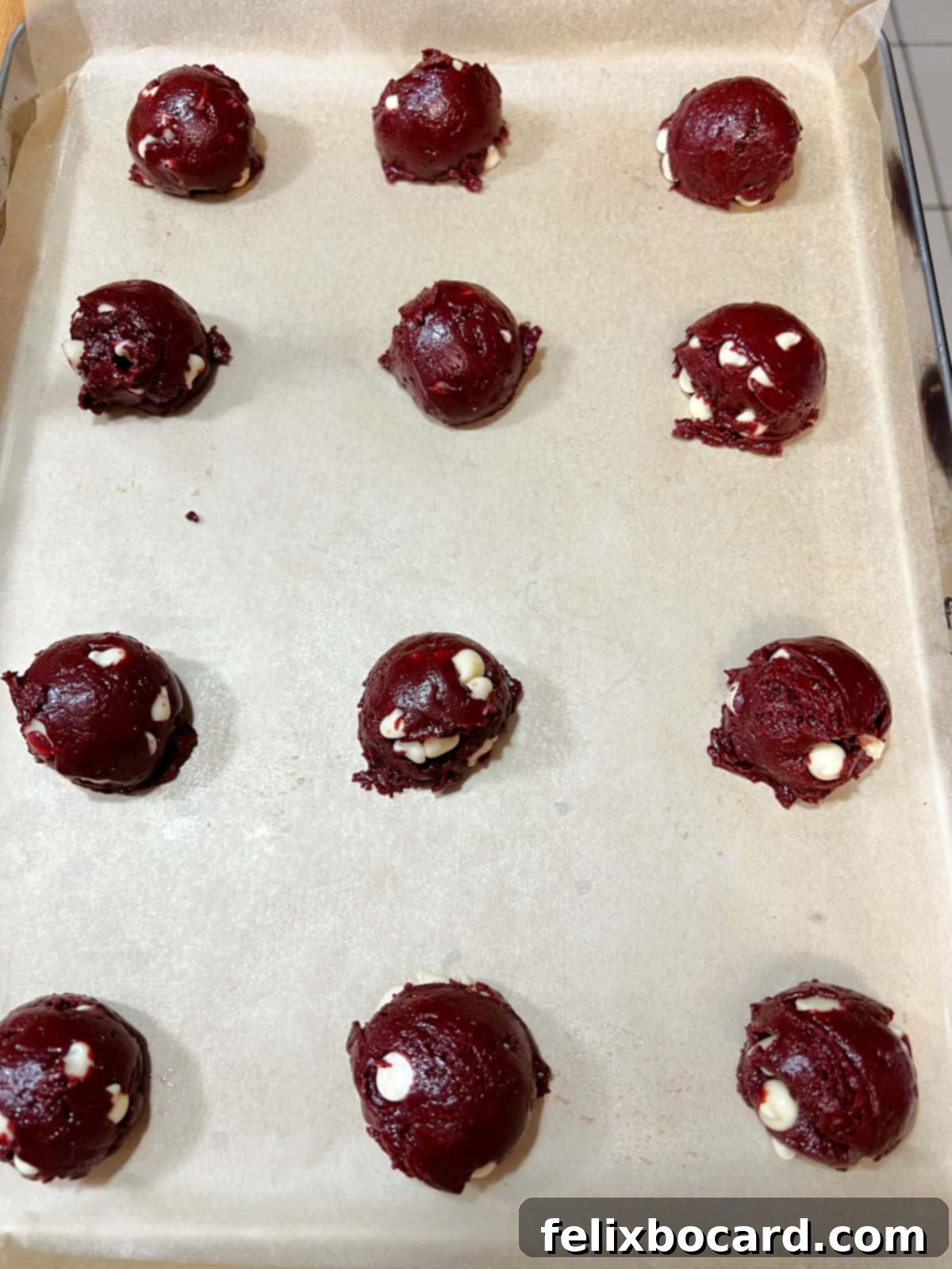 scoops of dough spaced out on a baking sheet.