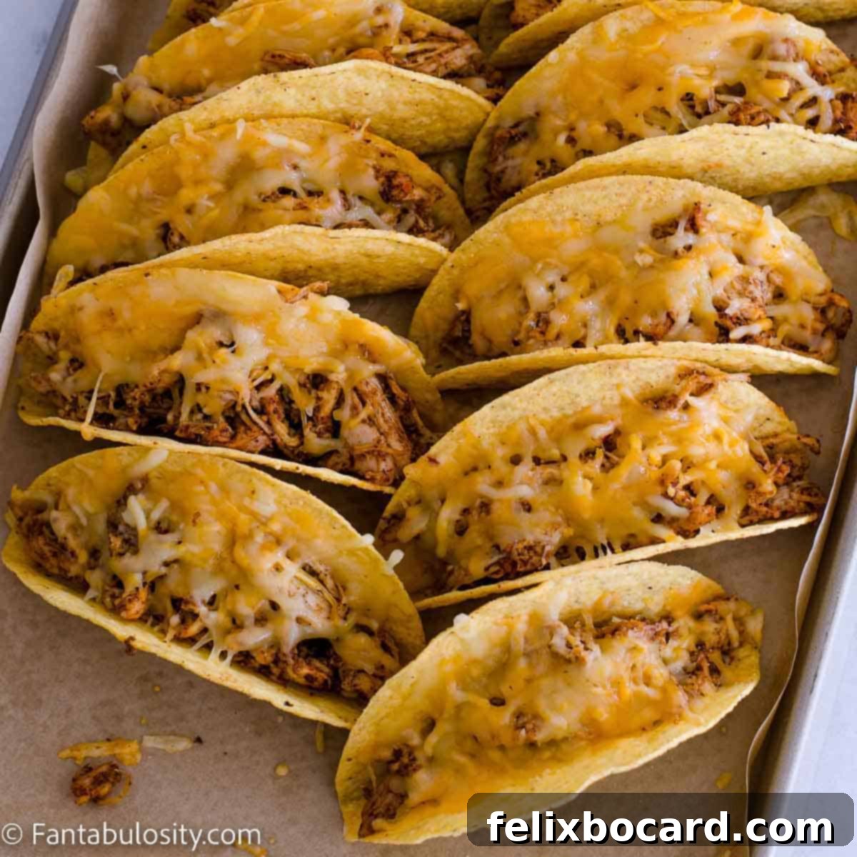 21 Delicious Makeovers for Your Leftover Shredded Chicken 19 A baking sheet filled with an appetizing array of crispy chicken tacos, ready to be enjoyed.