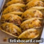 21 Delicious Makeovers for Your Leftover Shredded Chicken 20 Crispy chicken tacos neatly arranged on a baking sheet.