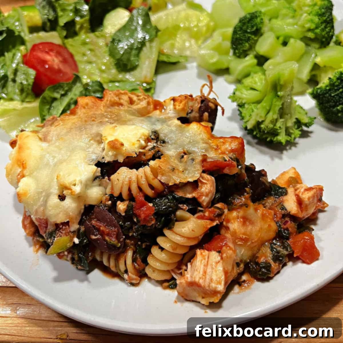 21 Delicious Makeovers for Your Leftover Shredded Chicken 30 A savory Greek Chicken Casserole served beautifully on a plate with a fresh side salad.
