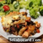 21 Delicious Makeovers for Your Leftover Shredded Chicken 31 Greek Chicken Casserole served on a plate, accompanied by a fresh salad.