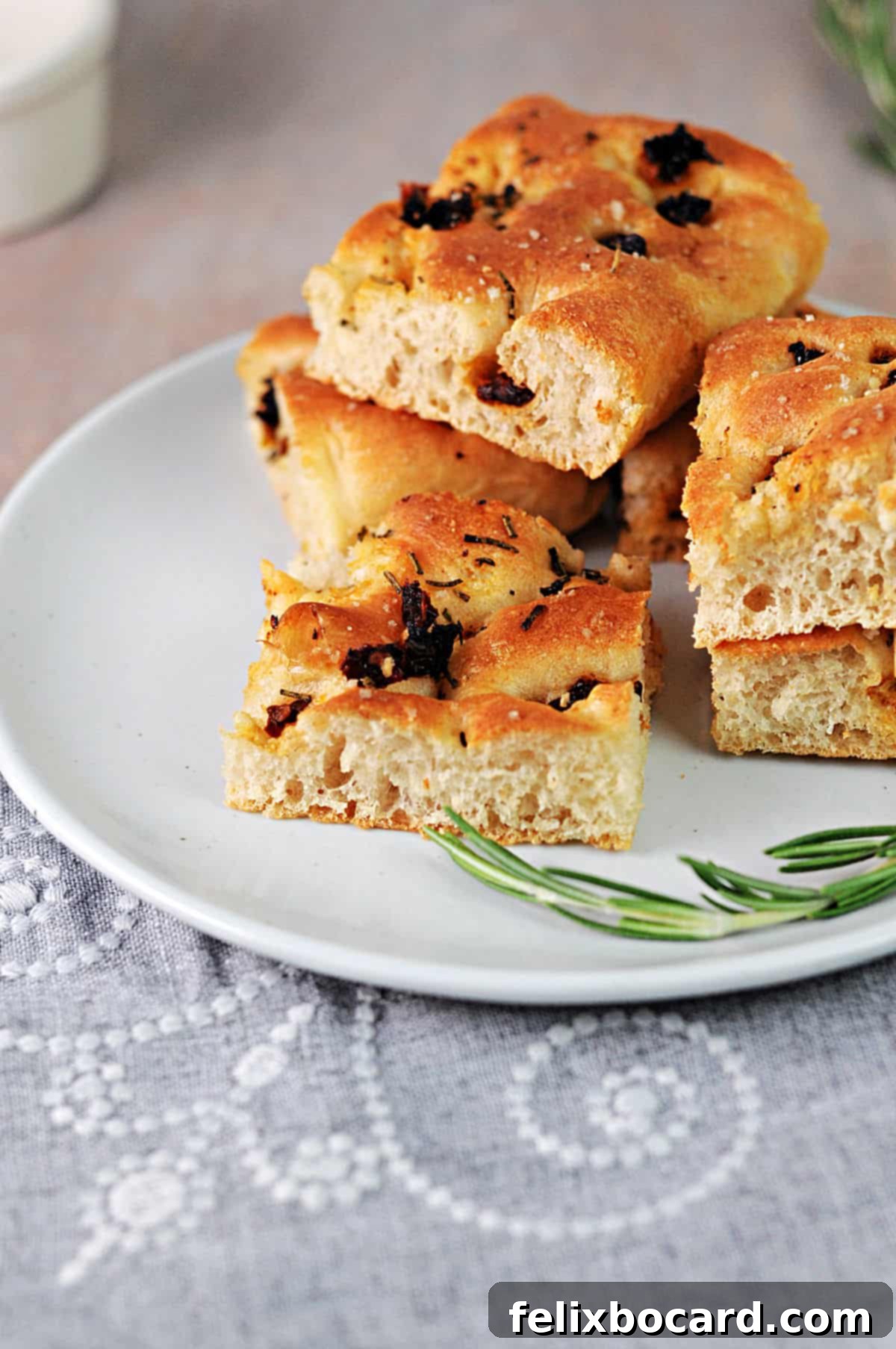 Simple Sun-Dried Tomato & Rosemary Focaccia 14 A thinner version of sun-dried tomato focaccia, baked in a larger pan, showcasing more crispy edges.