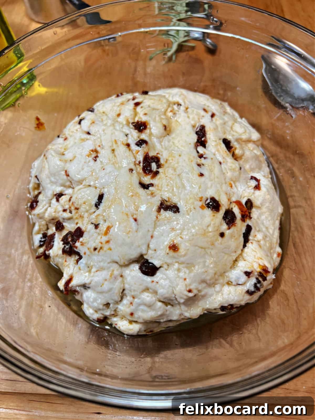Simple Sun-Dried Tomato & Rosemary Focaccia 5 Oil-covered focaccia dough resting in a large bowl, ready for its first rise.