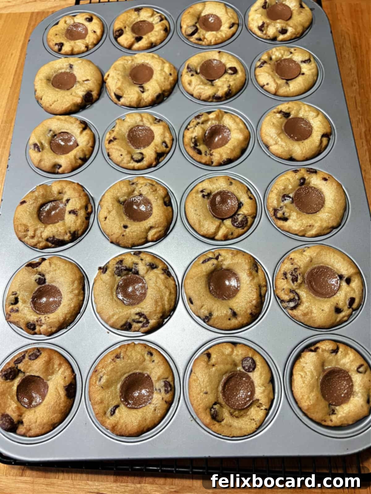 Freshly baked Rolo cookies still in the mini muffin pan, just out of the oven.