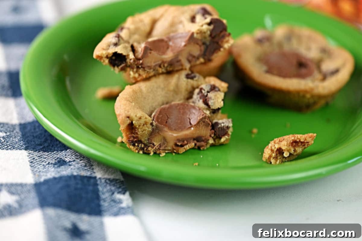 A cut open Rolo stuffed cookie cup, clearly showing the warm, gooey caramel center.