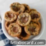 A small white plate stacked with Rolo stuffed chocolate chip cookie cups.