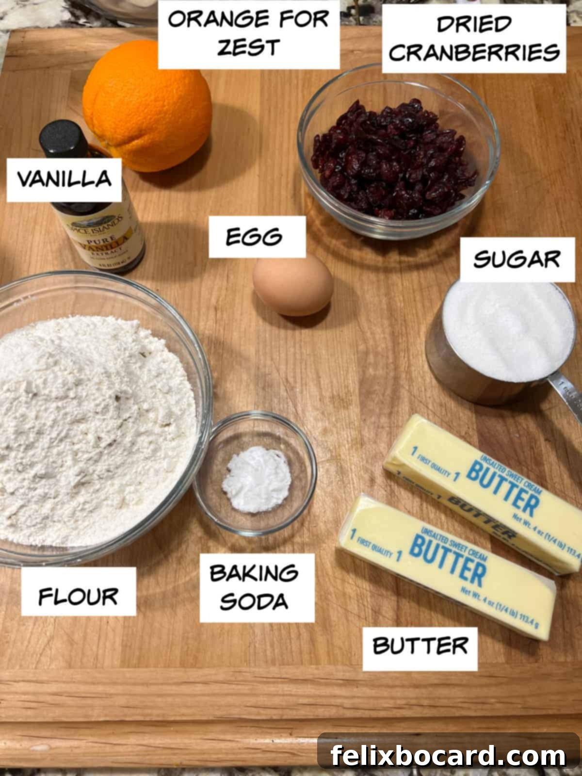 Ingredients: orange for zest, dried cranberries, vanilla, egg, sugar, flour, baking soda, and butter.