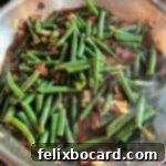 Texas Roadhouse copycat green beans cooking in a skillet.