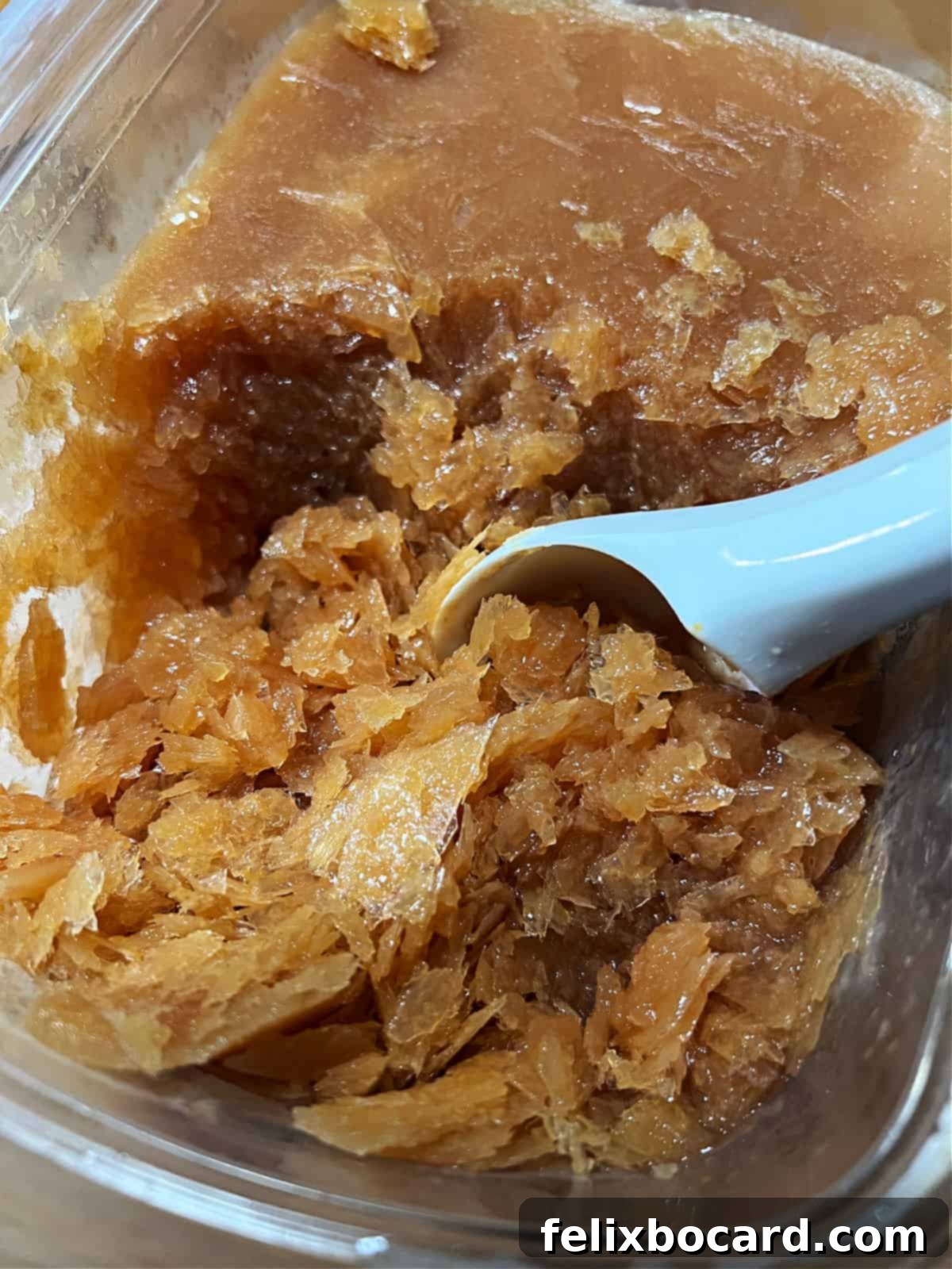 Zesty Cranberry Orange Vodka Chill 5 Ice cream scoop is scooping up the crystalline slushee mixture.