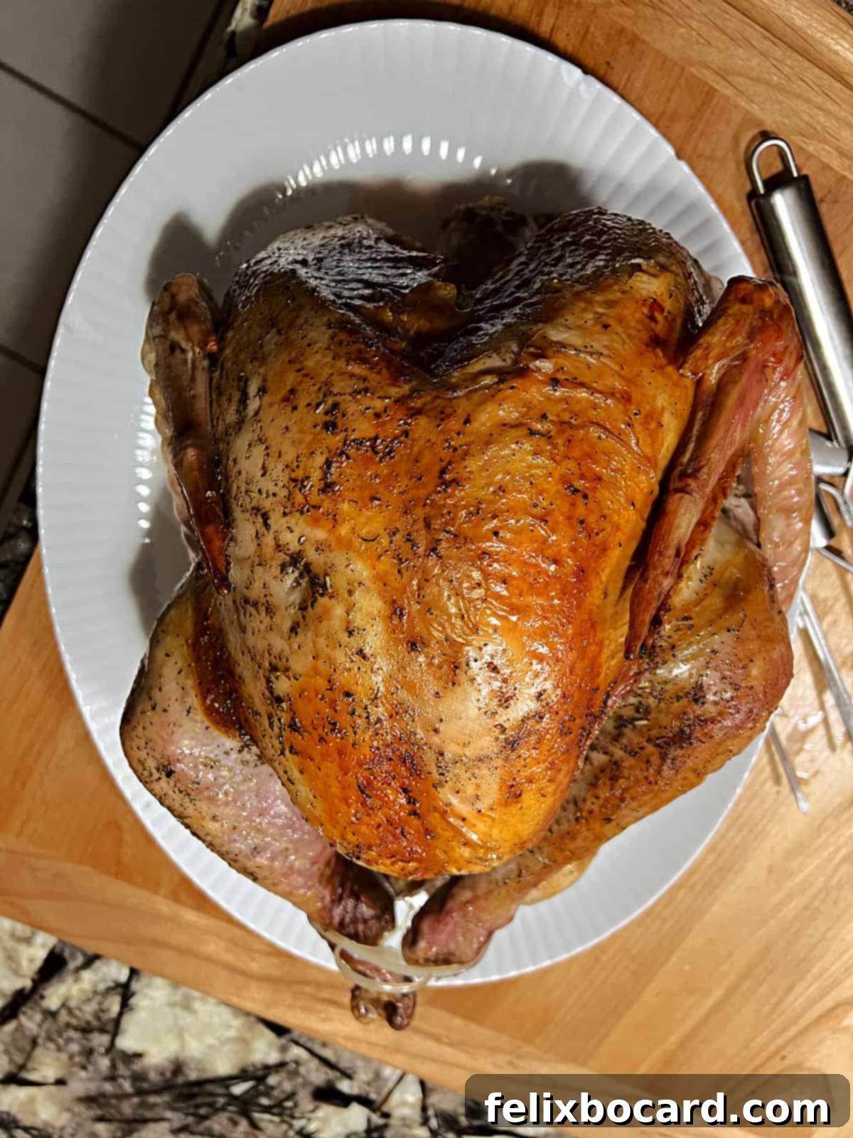 Roast turkey placed on a festive serving platter, ready for the holiday table.