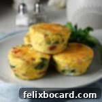 Savory Sausage and Egg Cups 11 Close-up of baked sausage and cheese egg bites in a square dish.